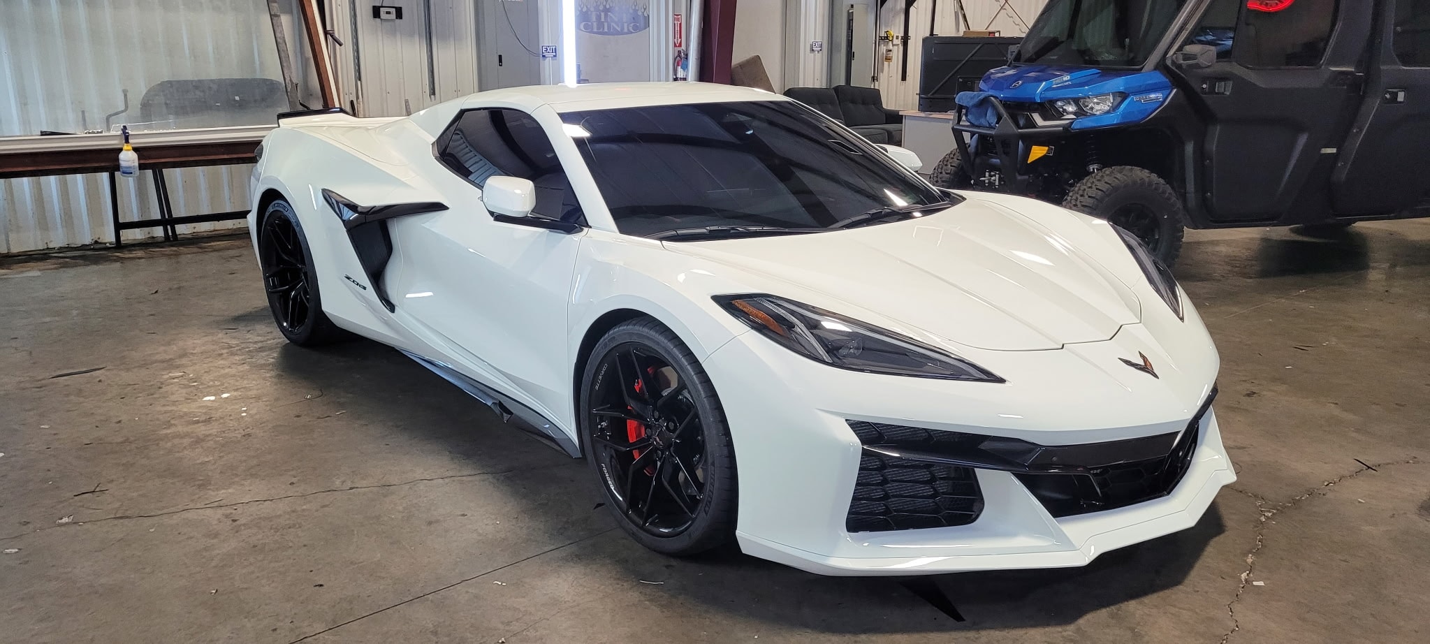 White Corvette Z06 front in garage workshop