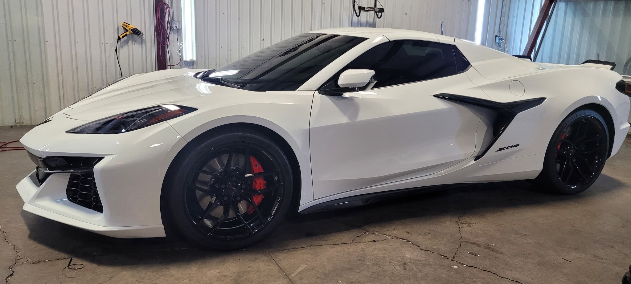 White Corvette Z06 side profile in garage